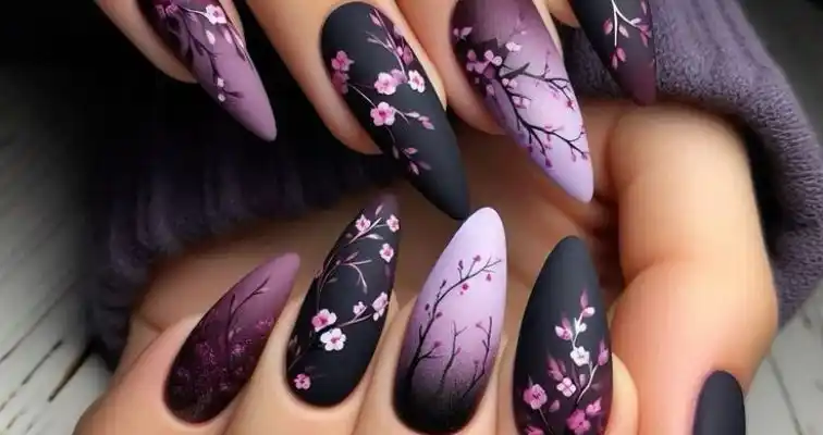 Almond acrylic nails with black and pink floral art. 