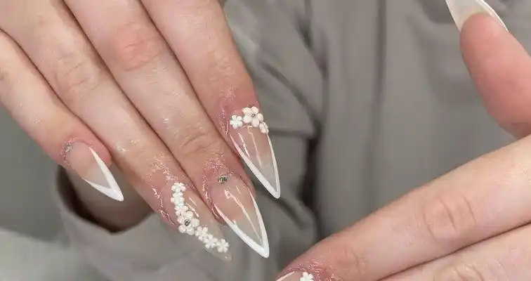 Elegant bridal nail design with acrylic flowers and French tips