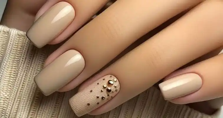 Simple nude nails with textured art and 3D studs. 