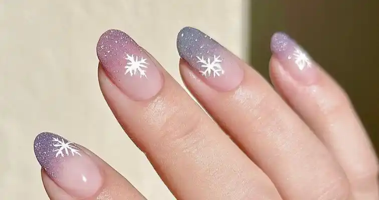 Winter nails with glitter ombre and snowflake designs. 