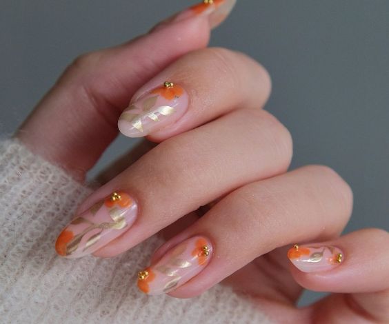  Nude nails with chrome leaf designs