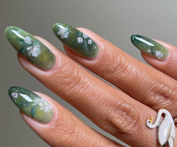 Green gel nails with white rose designs