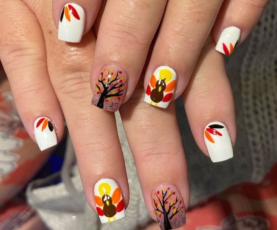 Short white nails with turkey and fall tree design for Thanksgiving