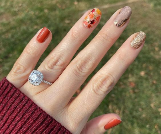 Thanksgiving nails with glitter, gold foil, and leaves nail art