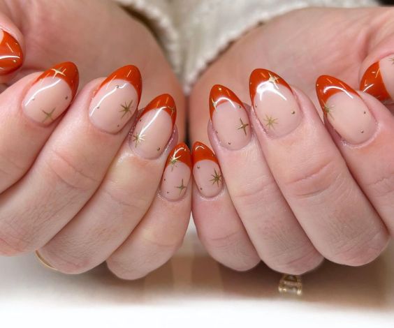 Simple orange French tips with shining star patterns