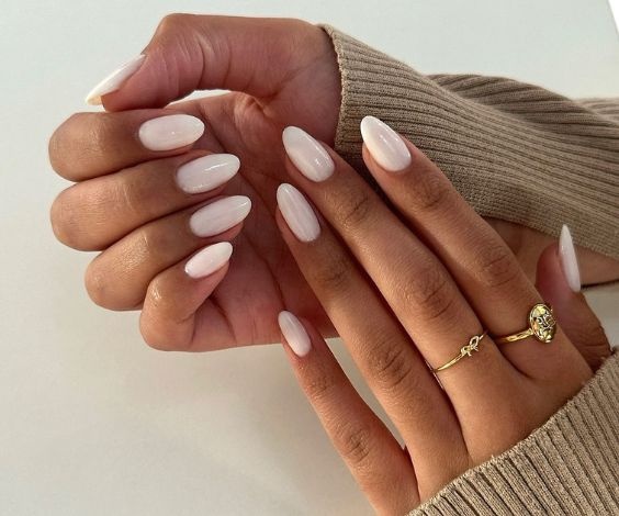 Elegant white lily nail color on almond nails. 