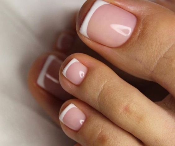 Clean French pedicure with white tips.