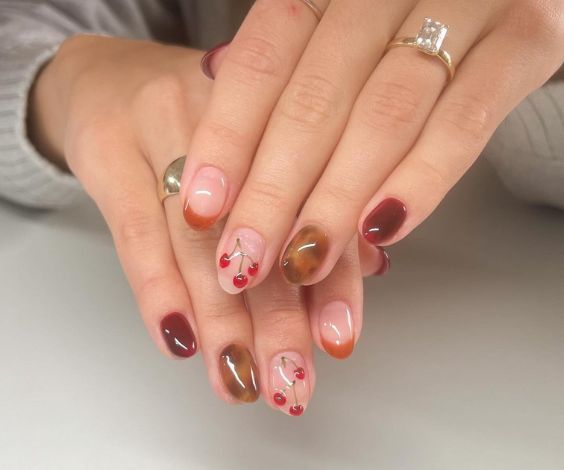 November Thanksgiving nails with animal print and cherry nail art. 