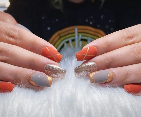 Orange and gray fall nails with foil nail art. 