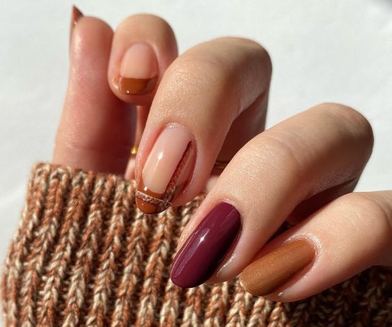 Plaid design and French tips with brown and plum nail colors. 