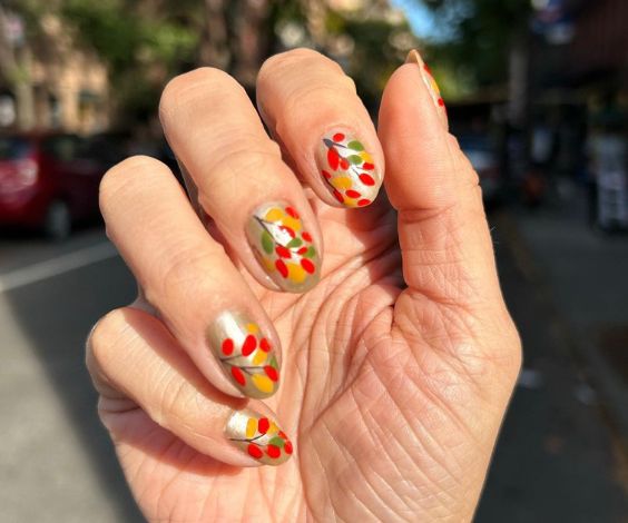 Cute November leaves nail art with silver accents and colorful leaves. 