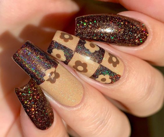 November nail art with check and flower designs using glitter nail paint. 