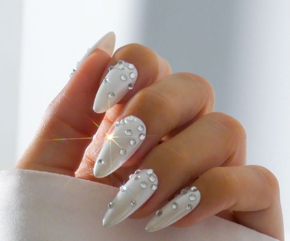 White nails with decorative pearls for a bedazzled look